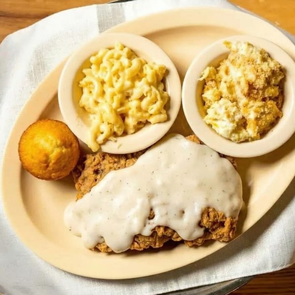 Chicken fried steak with gravy, mac and cheese, corn casserole, and a corn muffin.